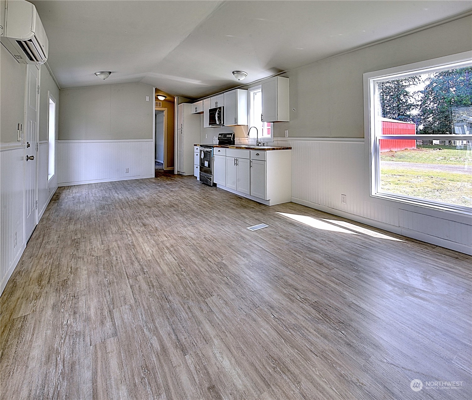 7230 196th Avenue Southwest Rochester, WA 98579 - Photo 29 of 39 a view of a kitchen with wooden floor and electronic appliances