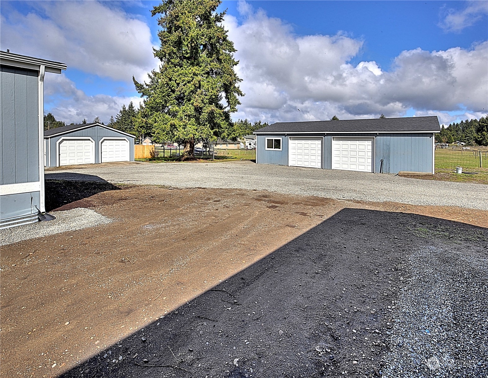 7230 196th Avenue Southwest Rochester, WA 98579 - Photo 3 of 39 a front view of a house with a yard and garage
