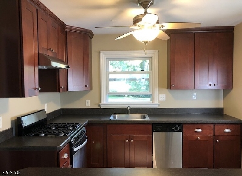 830 Bluestone Lane Bridgewater, NJ 08807 - Photo 8 of 29 a kitchen with granite countertop stainless steel appliances a sink stove and cabinets