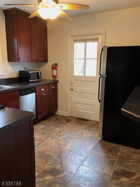 830 Bluestone Lane Bridgewater, NJ 08807 - Photo 9 of 29 a kitchen with a refrigerator and cabinets