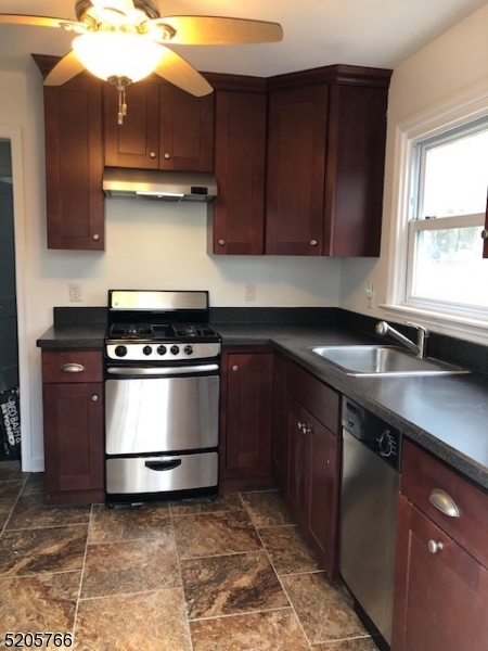 830 Bluestone Lane Bridgewater, NJ 08807 - Photo 10 of 29 a kitchen with a sink and a stove