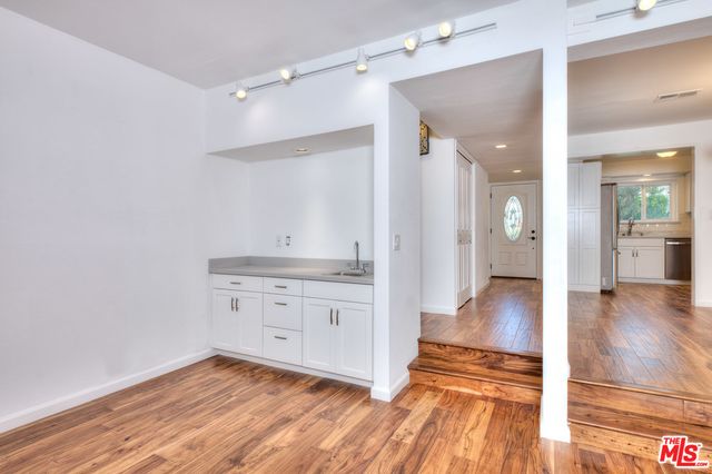 a spacious bathroom with a granite countertop sink and a mirror