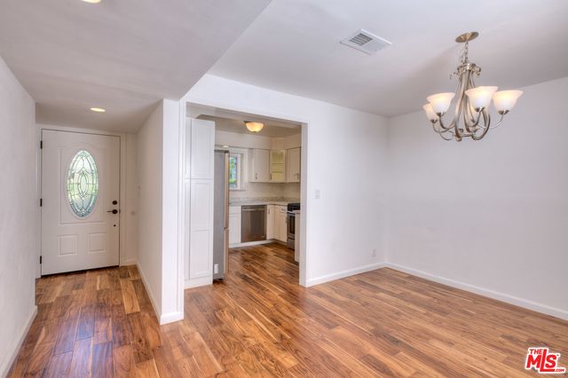 a kitchen with cabinets appliances a sink and a window