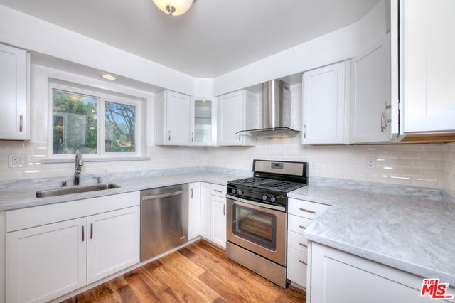 a kitchen with appliances cabinets and a counter top space