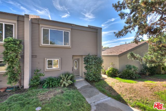 a view of a livingroom with wooden floor and a fireplace