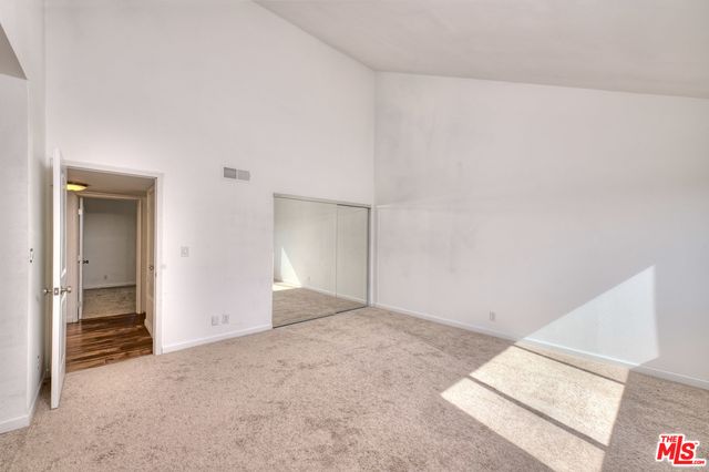 a spacious bathroom with a double vanity sink a mirror and a shower