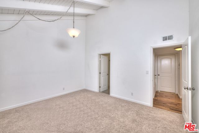 an empty room with windows and entrance