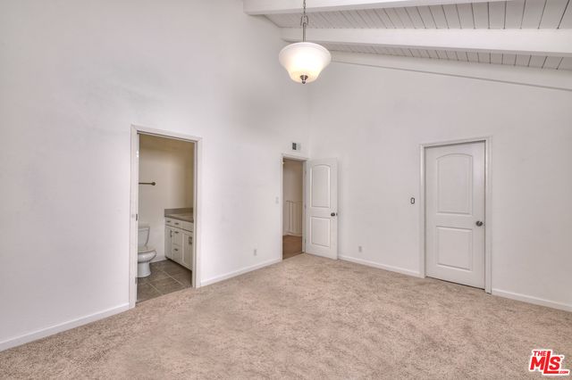 a bathroom with a granite countertop sink a toilet and mirror