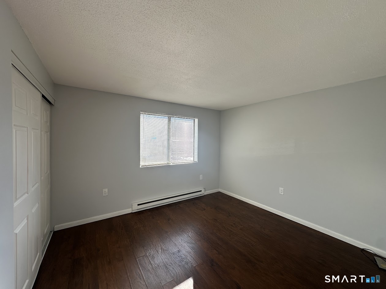 39 Horton Hill Road, Unit 7C Naugatuck, CT 06770 - Photo 11 of 29 an empty room with wooden floor and windows