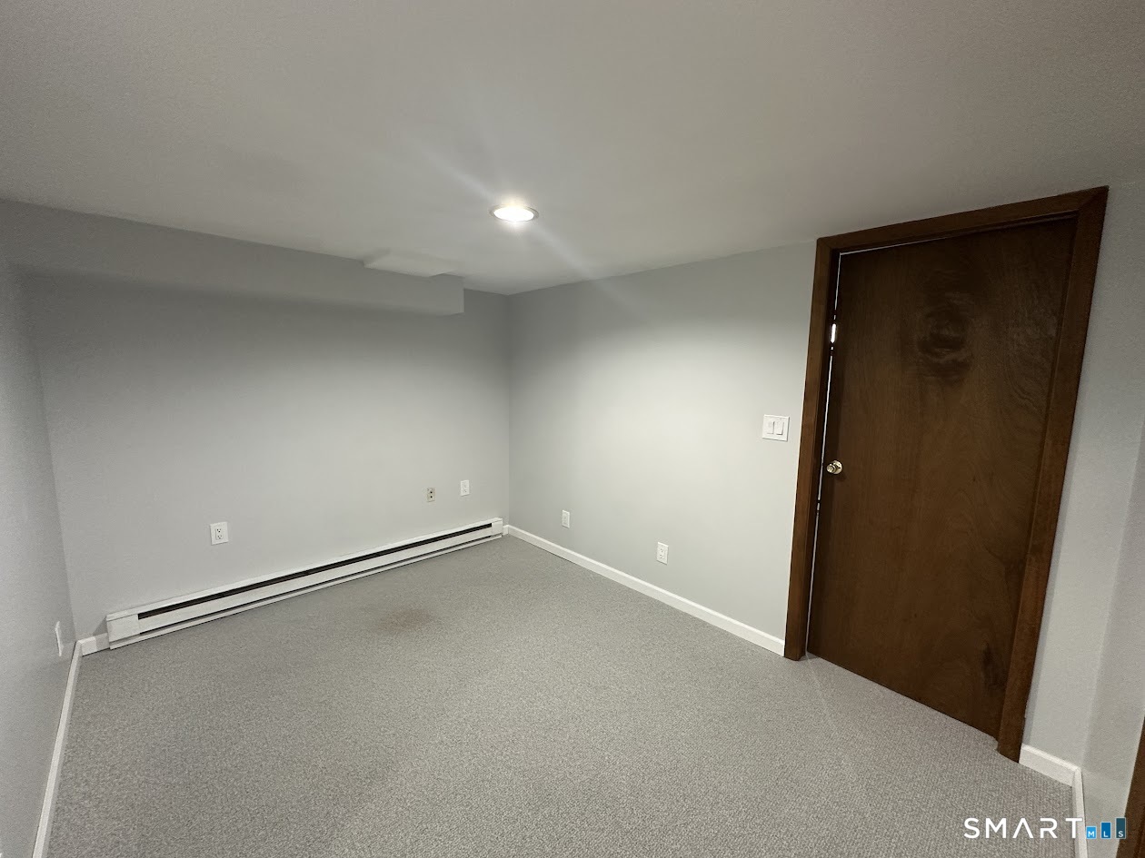 39 Horton Hill Road, Unit 7C Naugatuck, CT 06770 - Photo 19 of 29 an empty room with a workbench