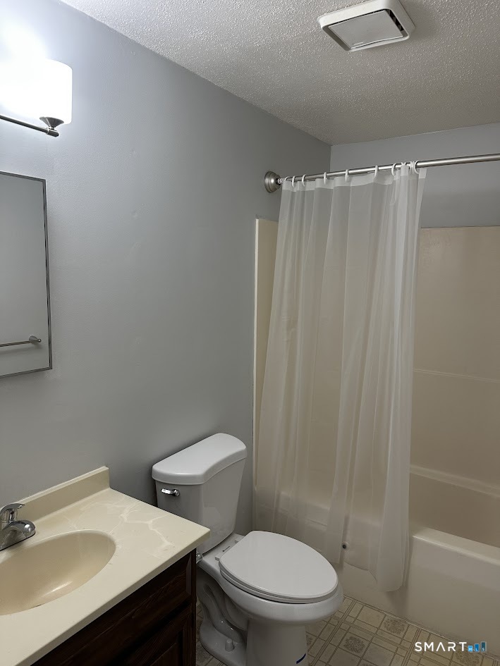 39 Horton Hill Road, Unit 7C Naugatuck, CT 06770 - Photo 26 of 29 a white toilet sitting next to a bathroom sink