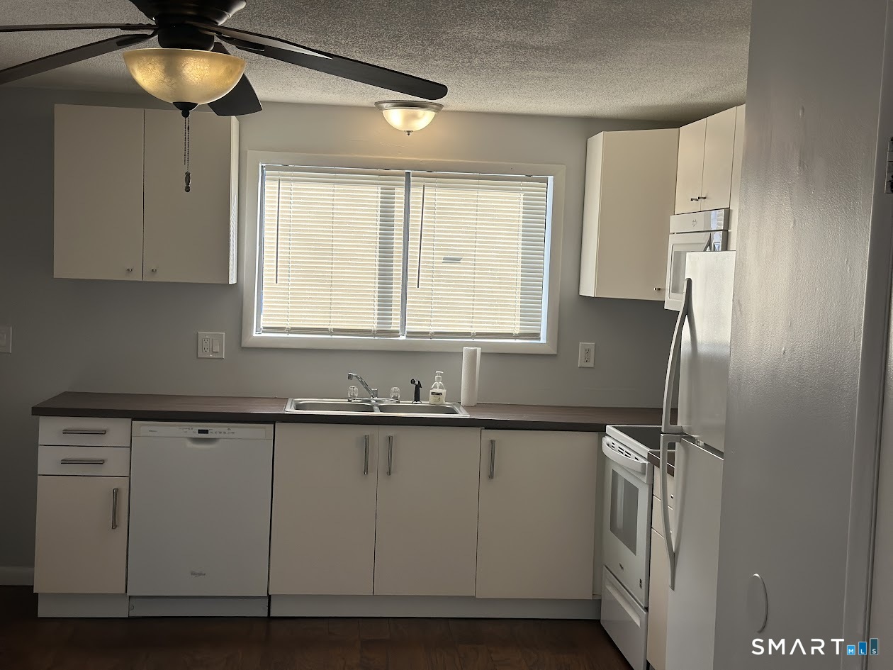 39 Horton Hill Road, Unit 7C Naugatuck, CT 06770 - Photo 5 of 29 a kitchen with stainless steel appliances a sink a refrigerator and cabinets