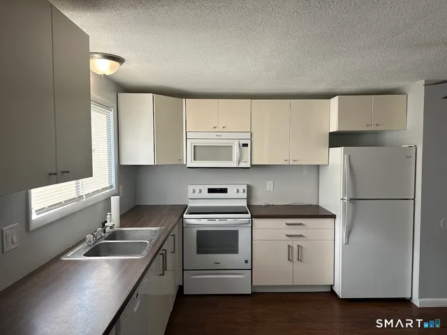 a kitchen with a sink stove and refrigerator