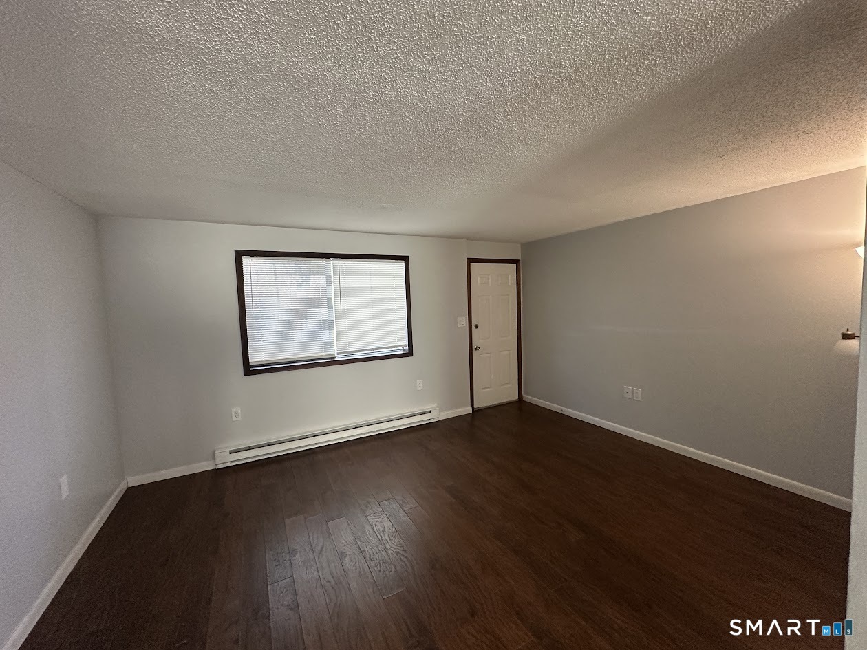 39 Horton Hill Road, Unit 7C Naugatuck, CT 06770 - Photo 7 of 29 a view of an empty room with wooden floor and a window