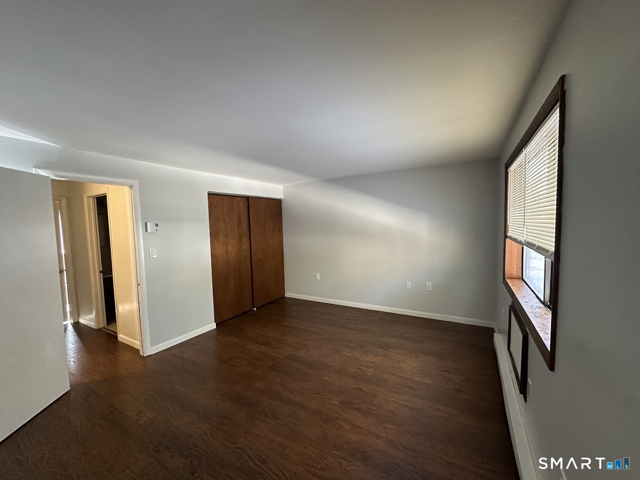 39 Horton Hill Road, Unit 7C Naugatuck, CT 06770 - Photo 10 of 29 an empty room with wooden floor and windows