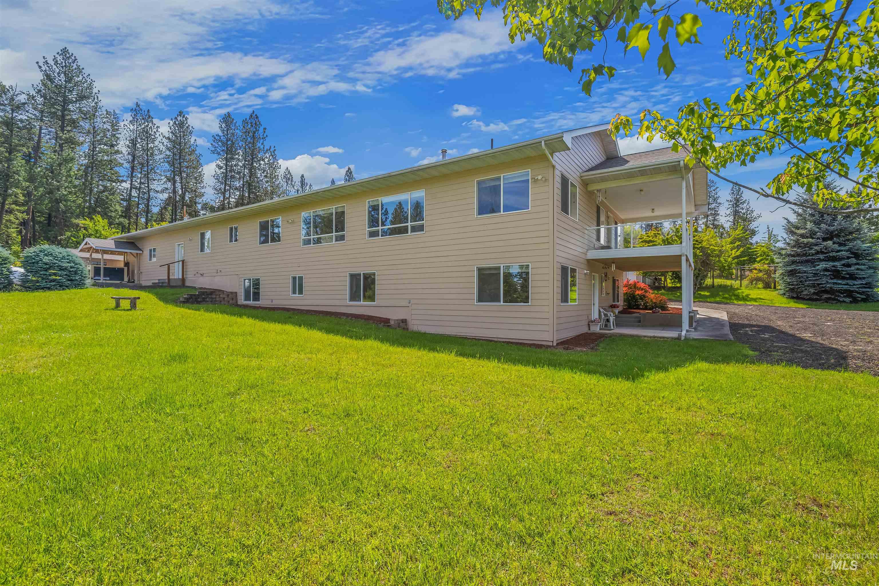 743 Wall Crk Road Stites, ID 83552 - Photo 12 of 48 Expansive side lawn fronting a two-story residence with light-colored siding