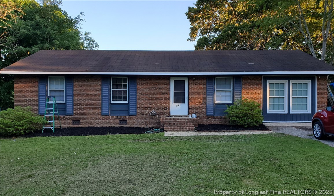 39 Gladiola Drive Spring Lake, NC 28390 - Photo 1 of 8 a view of a house with a yard potted plants and a table