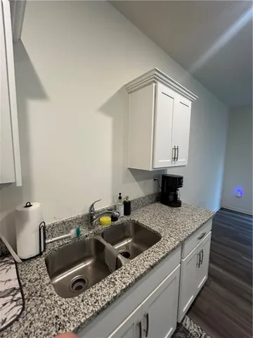 a kitchen with a sink cabinets and granite counter top