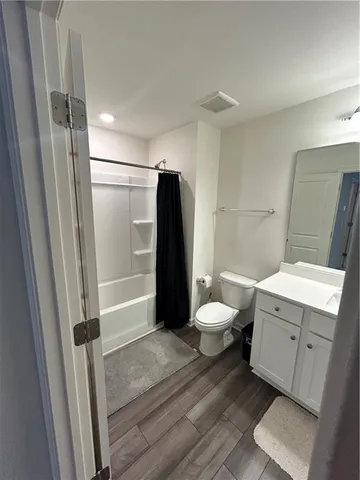 a bathroom with a granite countertop shower toilet and sink
