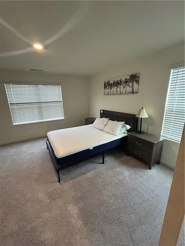 a bedroom with furniture and window