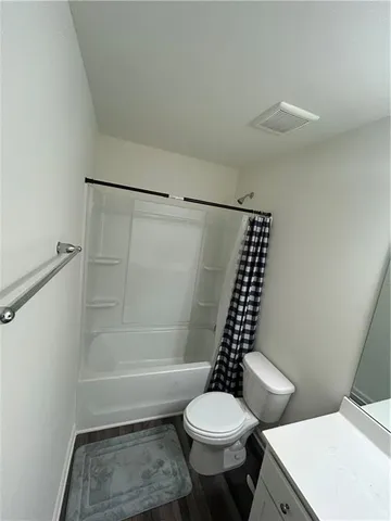 a bathroom with a toilet a sink and a shower