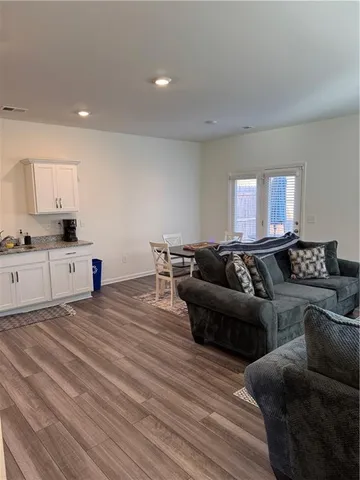 a living room with furniture and a wooden floor