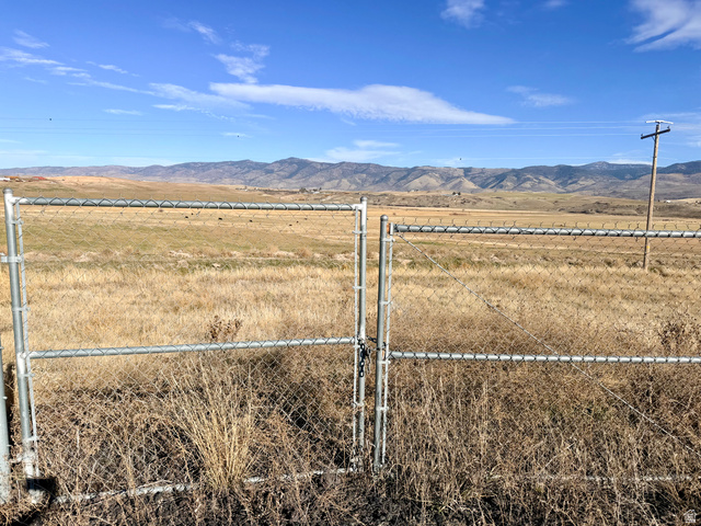 River Road Grace, ID 83241 - Photo 4 of 4 View of yard featuring a mountain view, a gate, and a view of countryside