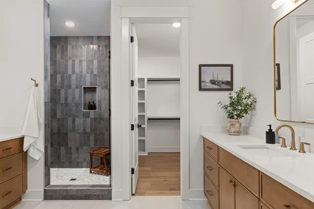 a bathroom with a shower sink and mirror