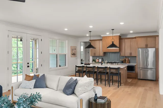 a living room with furniture a refrigerator and a dining table