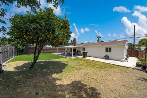 a view of a backyard with sitting area