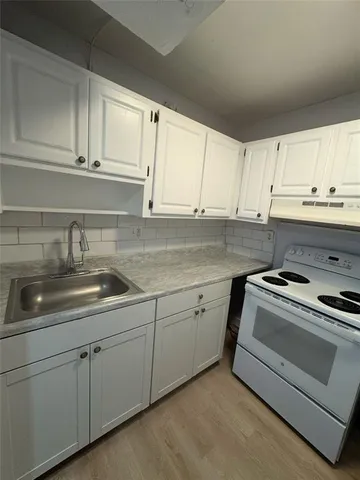 a kitchen with a sink and cabinets