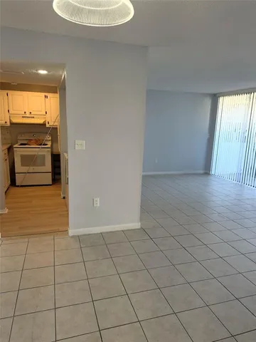 a view of a livingroom with an empty space and a window