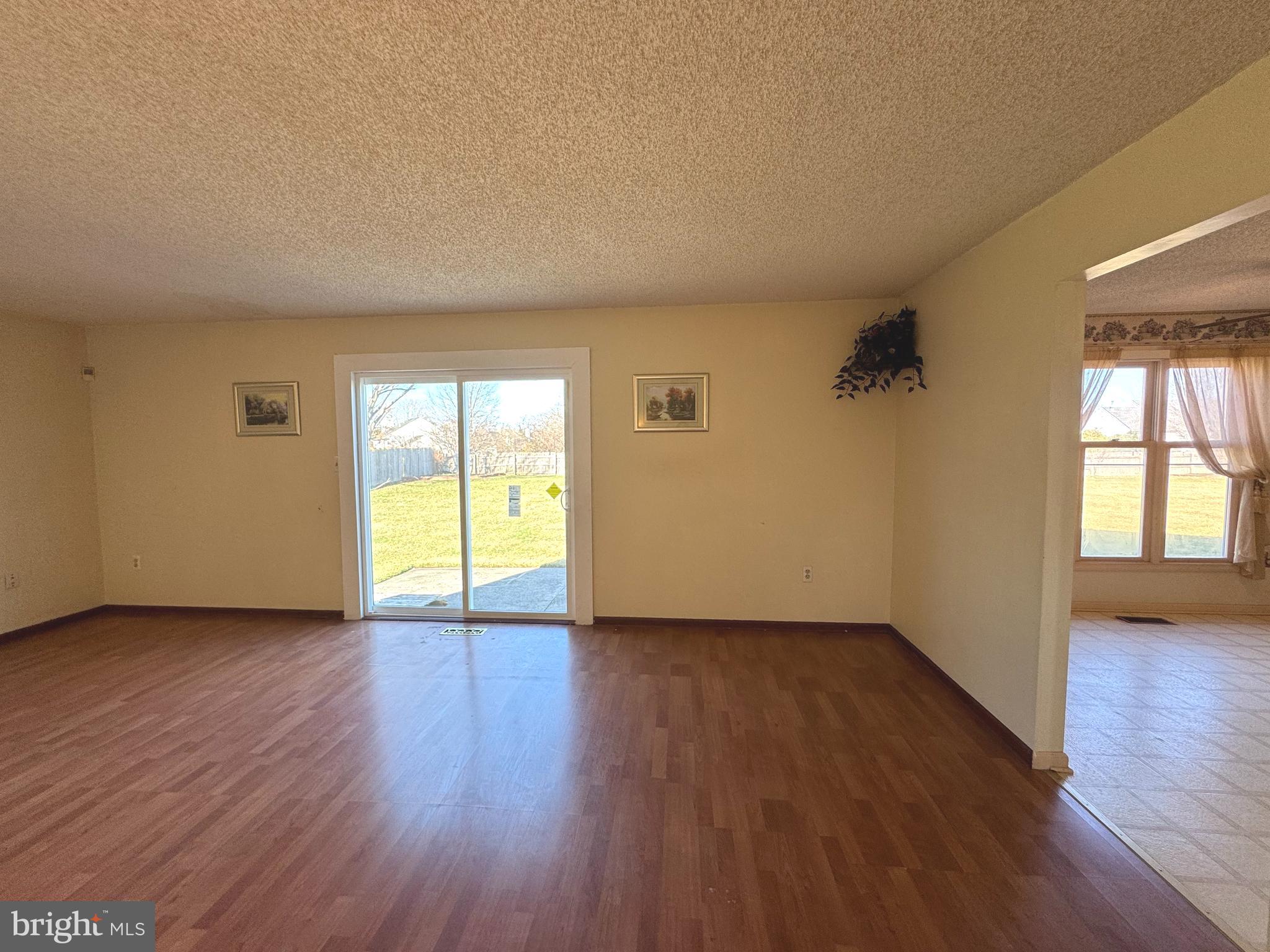 2530 Klockner Road Hamilton, NJ 08690 - Photo 5 of 16 an empty room with wooden floor and windows