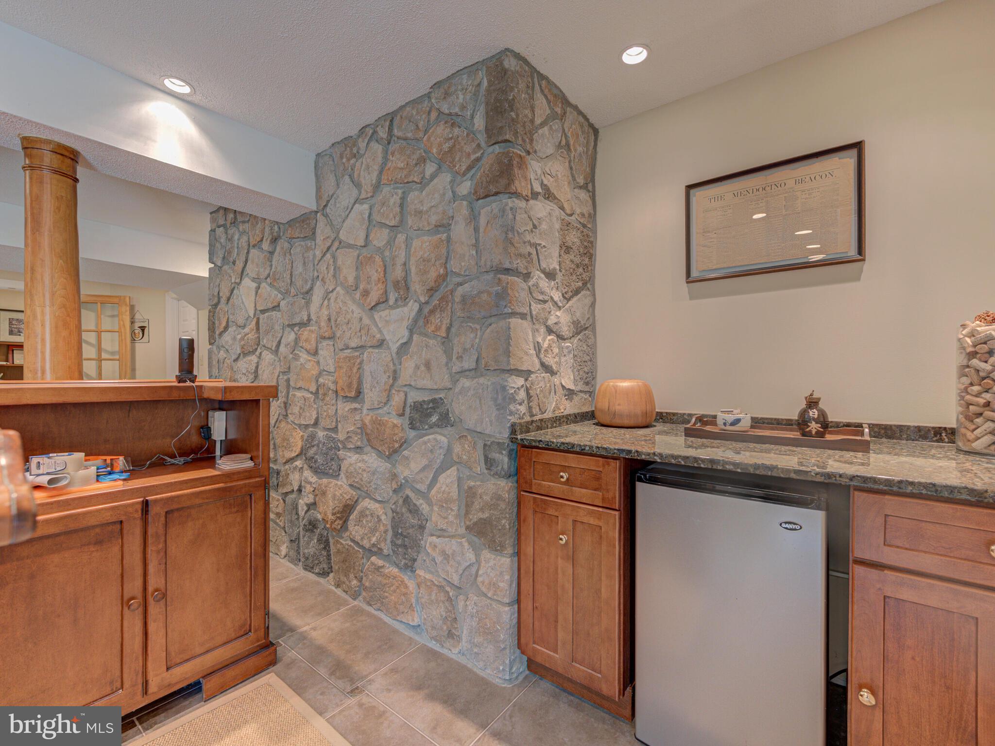16325 Whitehaven Road Silver Spring, MD 20906 - Photo 47 of 55 Wet Bar with Sink & Mini Fridge + Stone Wall
