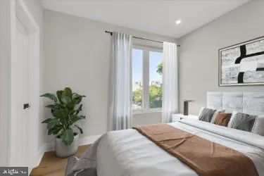 a bedroom with a bed and a potted plant