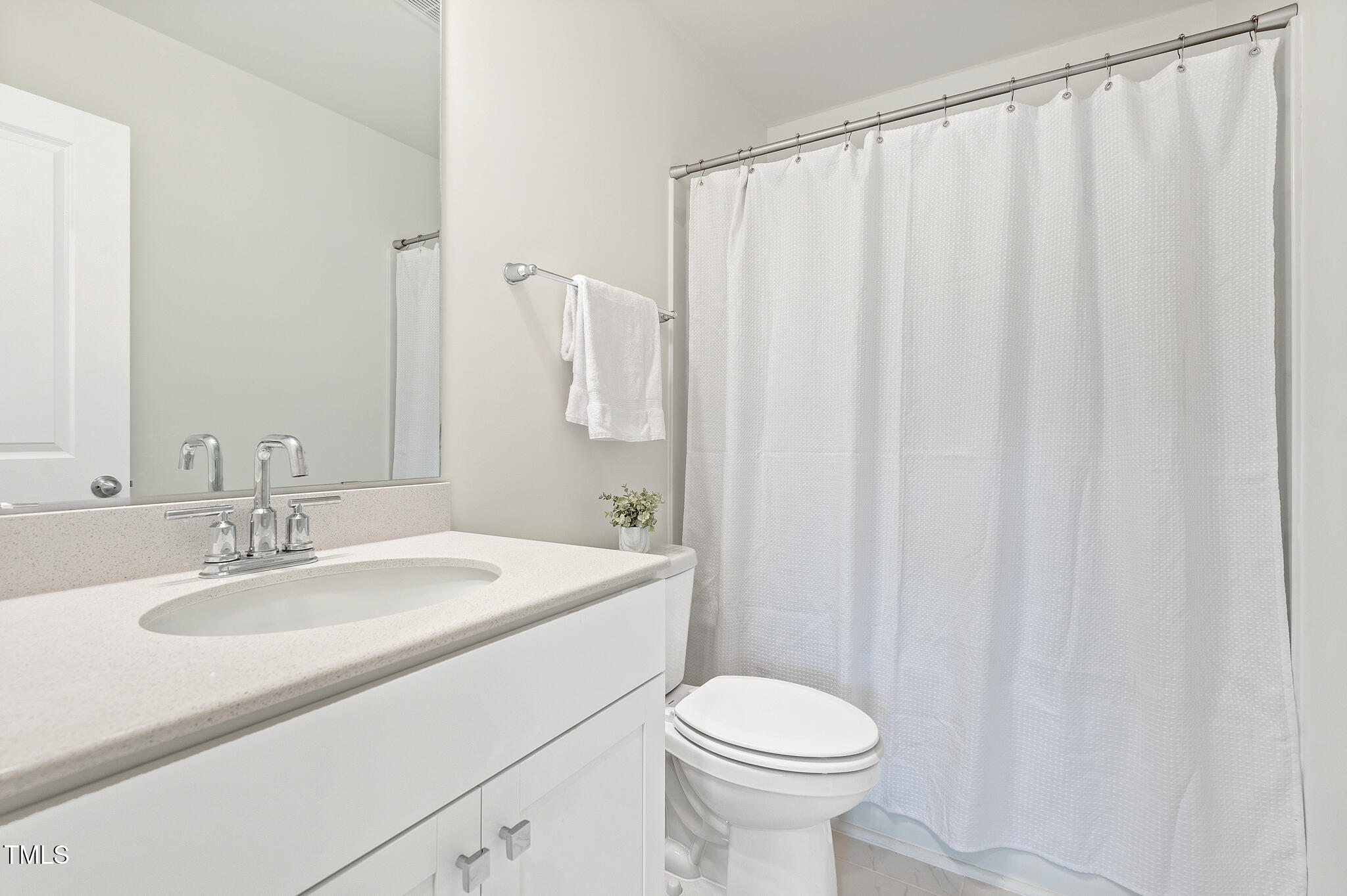 3028 Spline Circle Raleigh, NC 27610 - Photo 23 of 27 a bathroom with a sink a toilet and shower curtain
