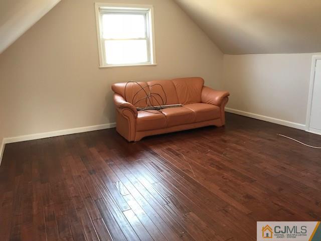 21 Kendall Road East Brunswick, NJ 08816 - Photo 12 of 21 a blue couch sitting in a room next to a window