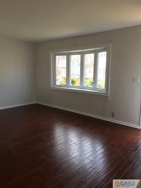 21 Kendall Road East Brunswick, NJ 08816 - Photo 4 of 21 a view of an empty room with wooden floor and a window