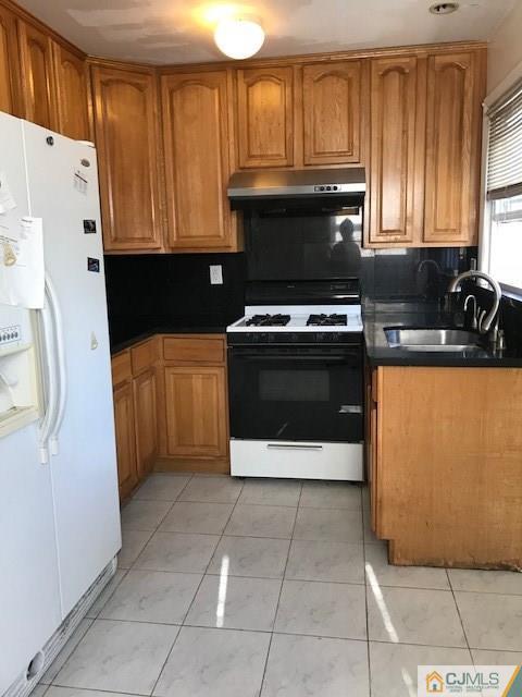 21 Kendall Road East Brunswick, NJ 08816 - Photo 6 of 21 a kitchen with a stove top oven and cabinets