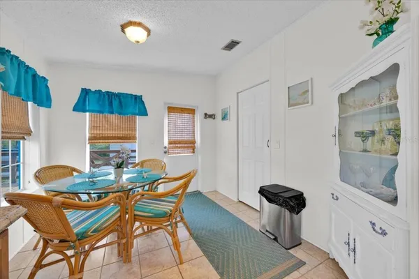 a dining room with furniture and wooden floor