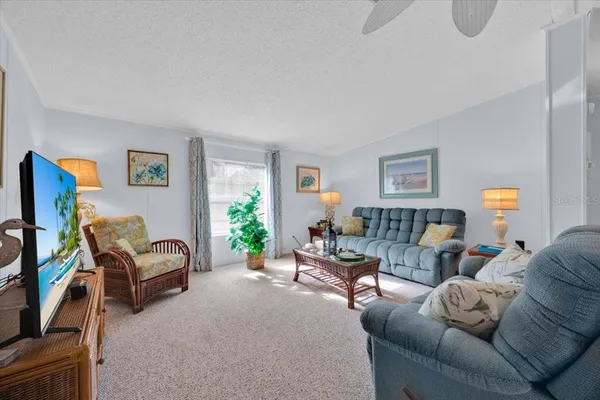 a living room with furniture a couch and a flat screen tv