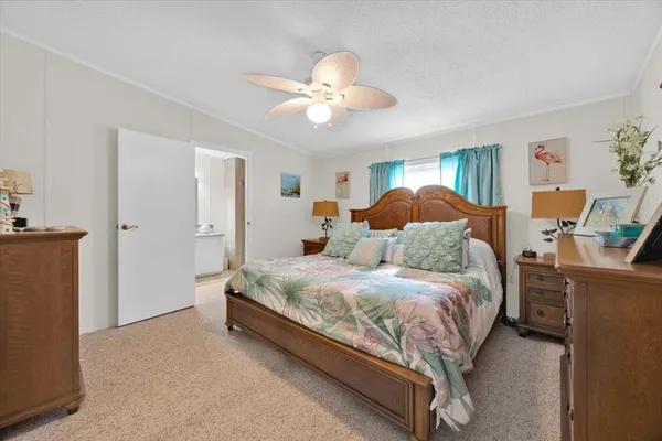 a bedroom with a large bed and a chandelier