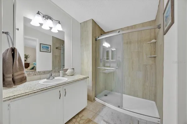 a bathroom with a tub a sink and mirror