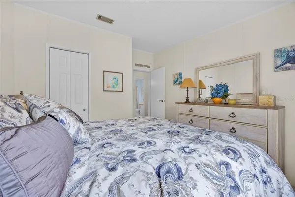a bedroom with a bed and a dresser