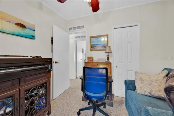a bedroom with furniture and a mirror