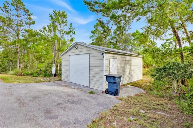 a view of backyard with a table and chairs