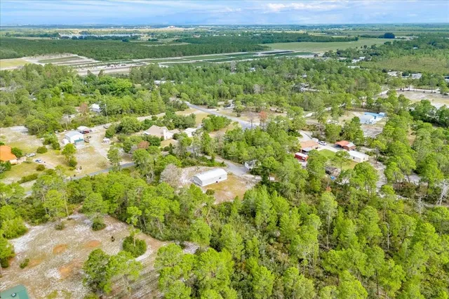 a backyard of a house with lots of green space and trees