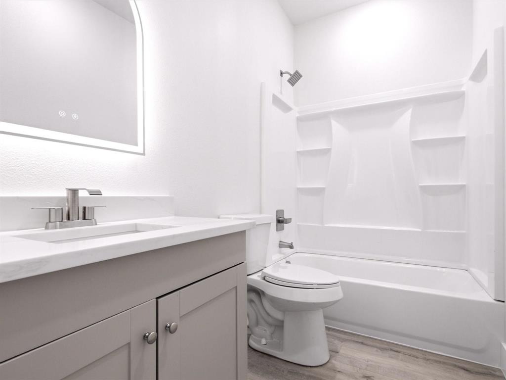 105 Oak Ridge Road Mabank, TX 75156 - Photo 20 of 34 Bathroom featuring a light gray vanity with a white countertop, undermount sink, and brushed nickel faucet