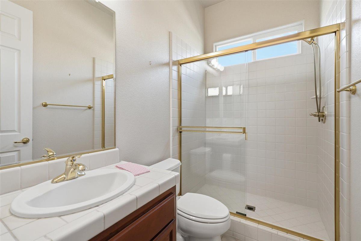 4129 Poppleton Way Carmichael, CA 95608 - Photo 23 of 48 a bathroom with a sink a mirror toilet and shower