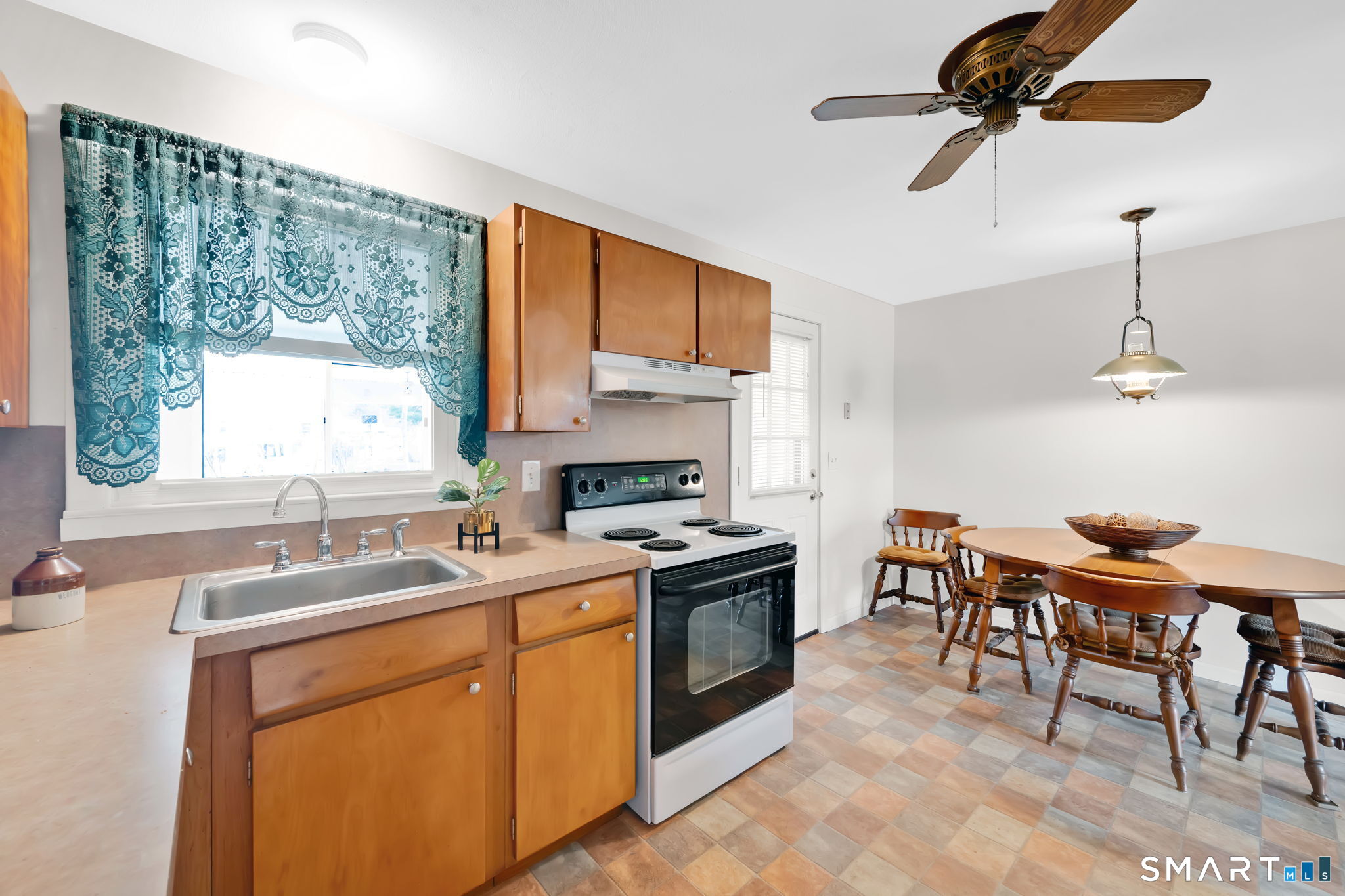 50 Carr Street Wallingford, CT 06492 - Photo 13 of 34 a kitchen that has a sink a stove and chairs